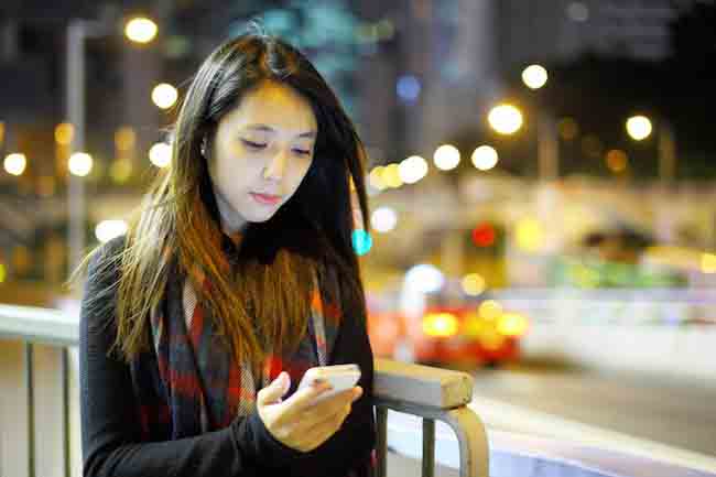 woman using mobile at night